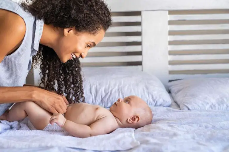 mother completing a diaper change