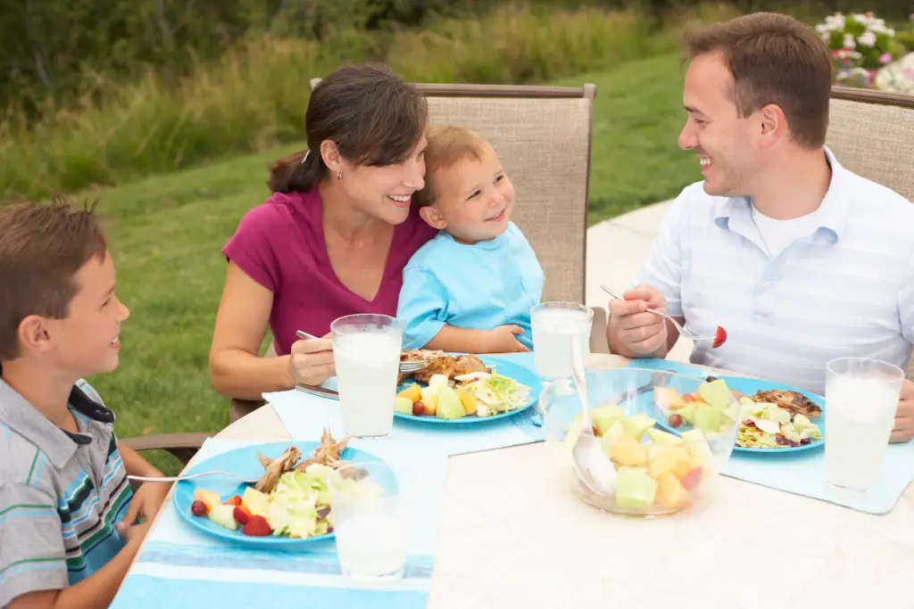 family with toddler enjoying meal together